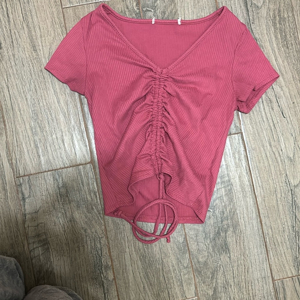 This is a pink that can be turned into cropped or be warn as a cute tee